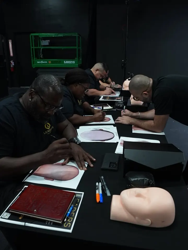 Students practising at a table with training heads